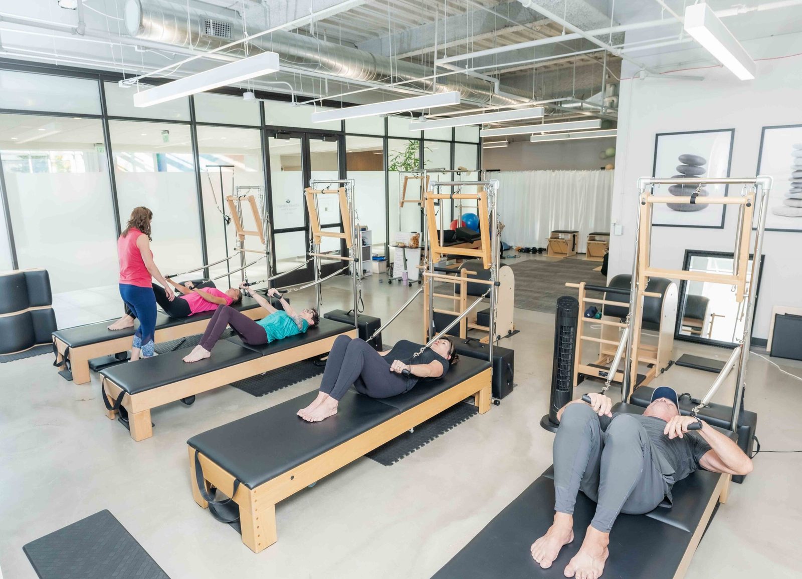 A group reformer class in session at Denver Pilates Girl